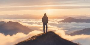 Warm watercolor illustration of a person standing on a mountain peak at sunrise, looking contemplative rather than celebratory, soft earth tones